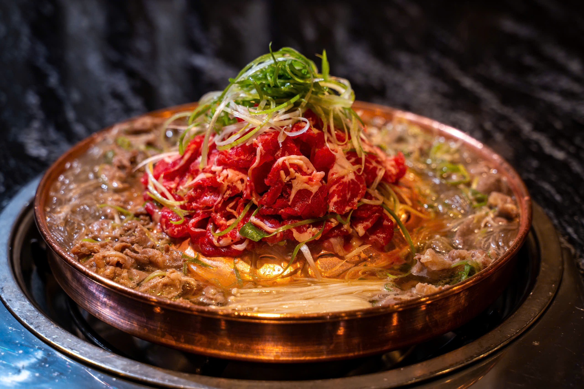 Seoul Bulgogi copper hotpot with beef and scallions